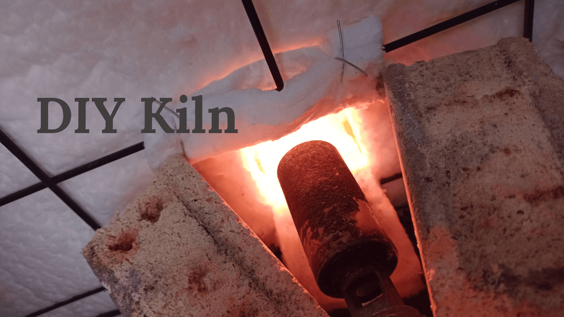 Close-up of a DIY kiln built from a disused dog crate, showcasing the heat source and construction details. DIY Pottery Kiln.